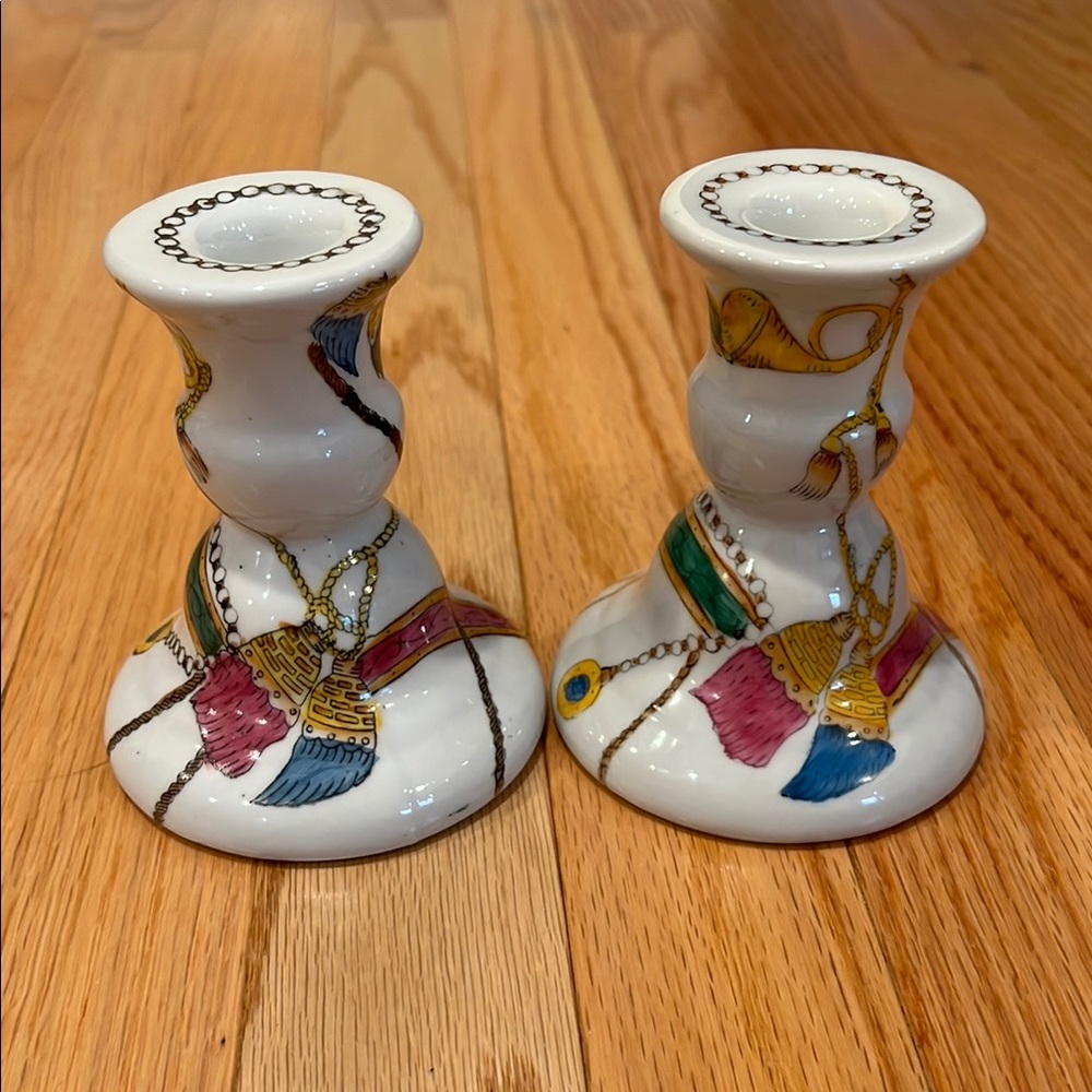 A pair of tassel, drum and chain porcelain candlesticks